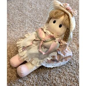 Vintage Berkeley Designs musical rag doll holding a bow